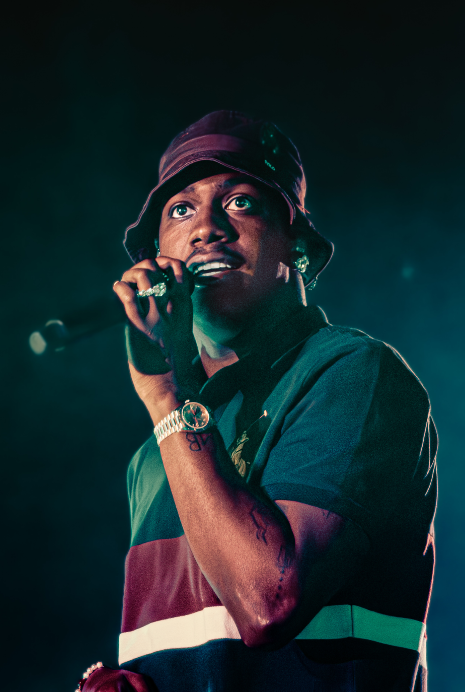 Hip-hop artist performing with a microphone wearing a beanie